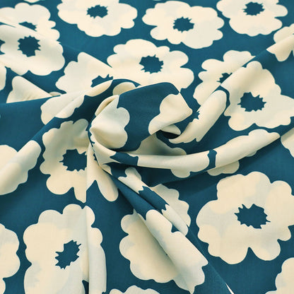 100% Viscose Floral Viscose Fabric featuring a bold modern floral in cream on a petrol blue-green background