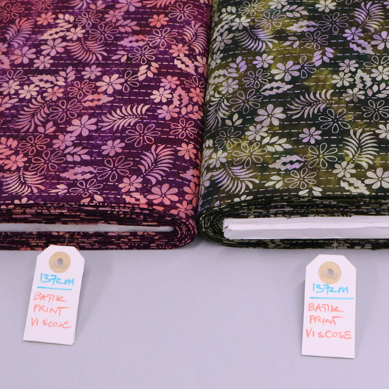 Floral batik fabrics in 100% viscose in dark green and dark pink